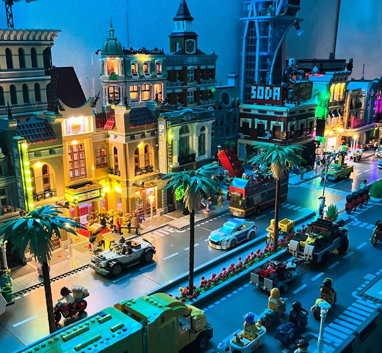 LEGO® modular buildings under night lighting with BrightMyBricks LED kits – cozy city vibes.
