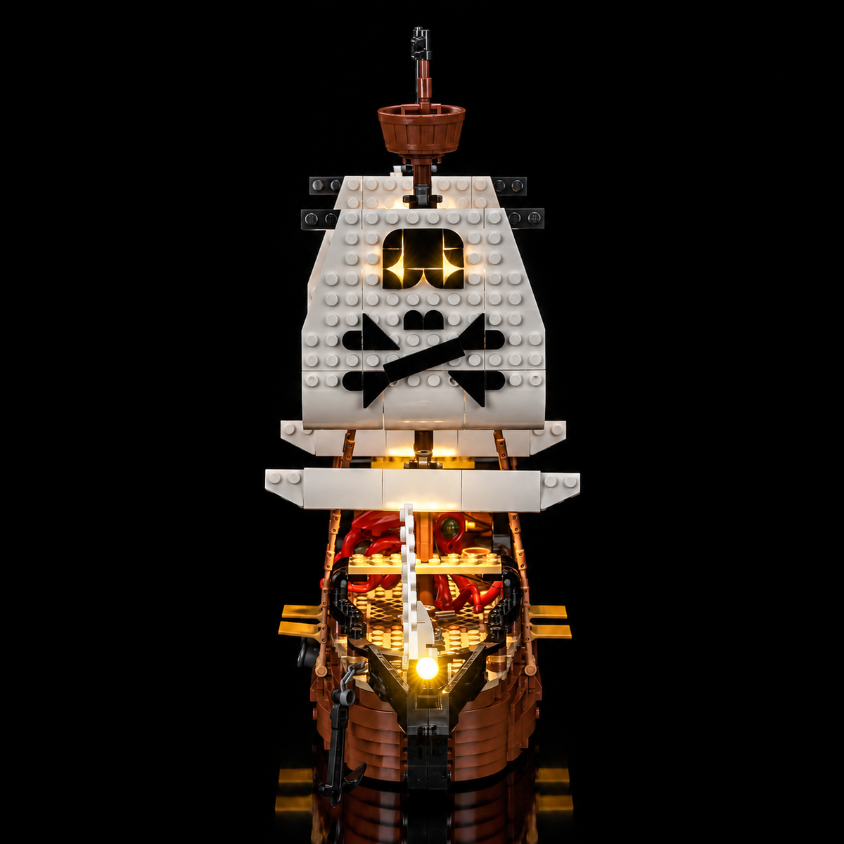 Head-on view of LEGO Iconic Pirate Ship 31387 with a glowing bow light and lit main sail