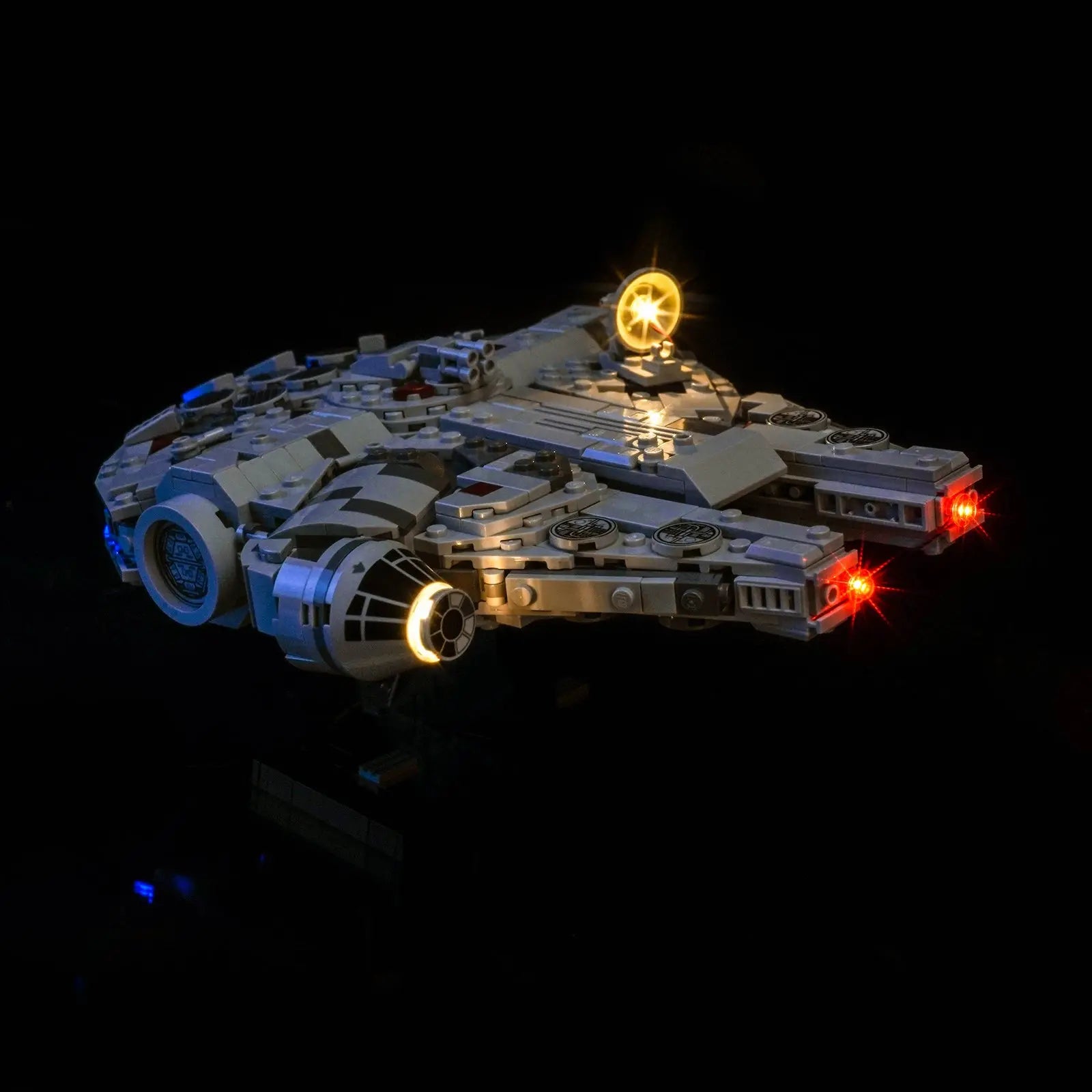 The LEGO Millennium Falcon 75375 mounted on its display stand, expertly lit by a Bright My Bricks kit for collectors.