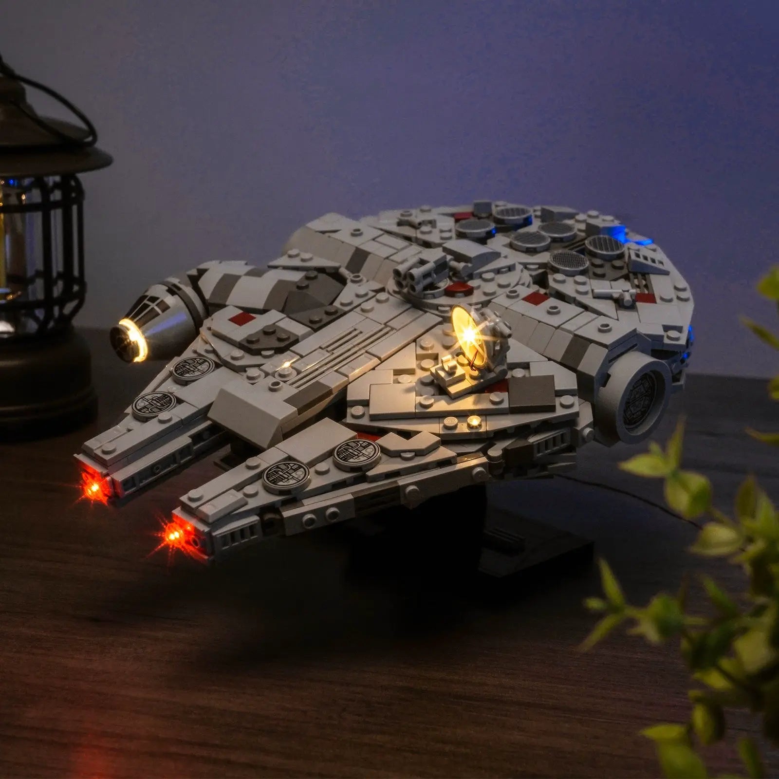 The LEGO Millennium Falcon 75375 shown in a dark room, where the Bright My Bricks lights create a dramatic silhouette.