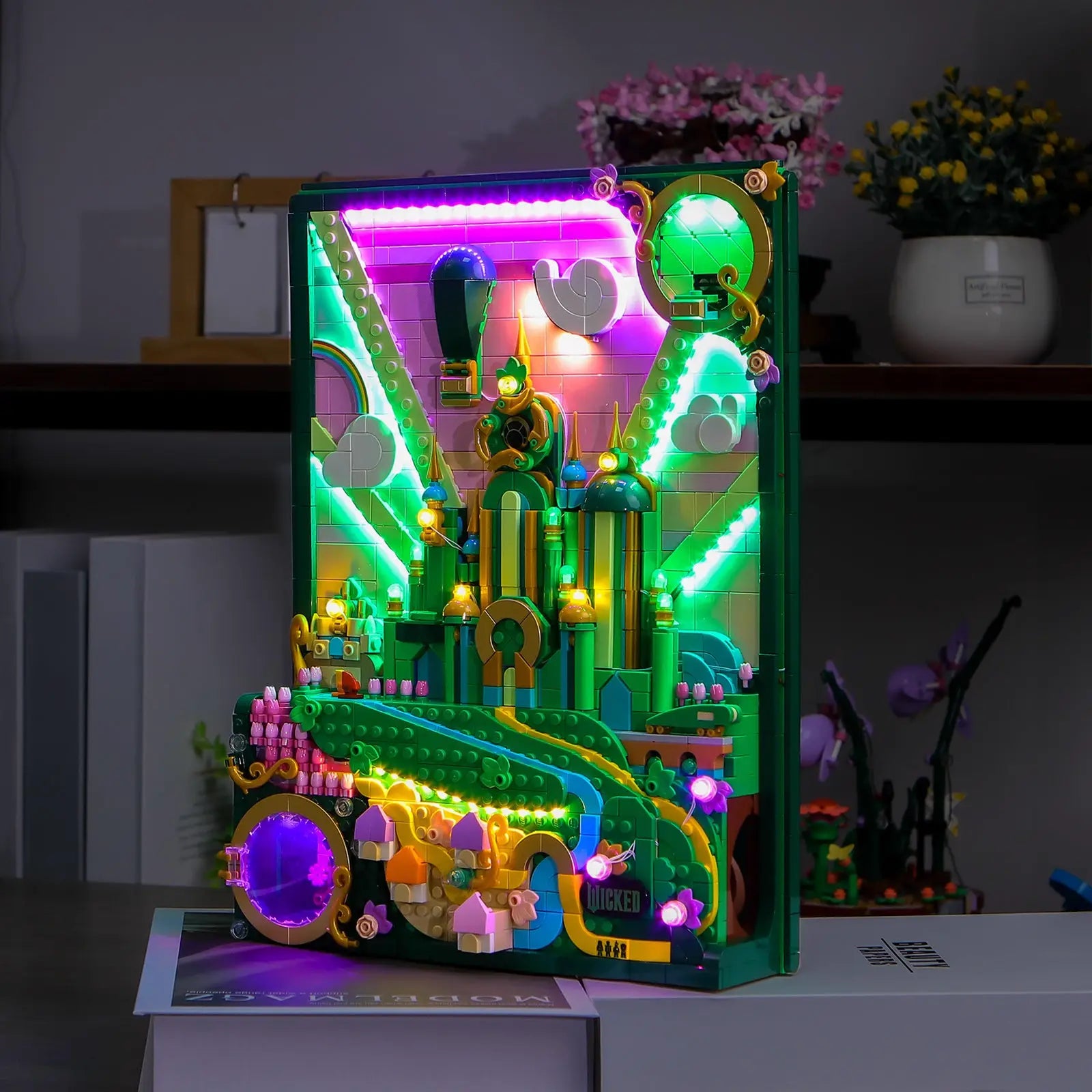 A detailed shot where subtle lighting highlights the micro-figures of Elphaba and Glinda in the LEGO Wicked 75685 set.