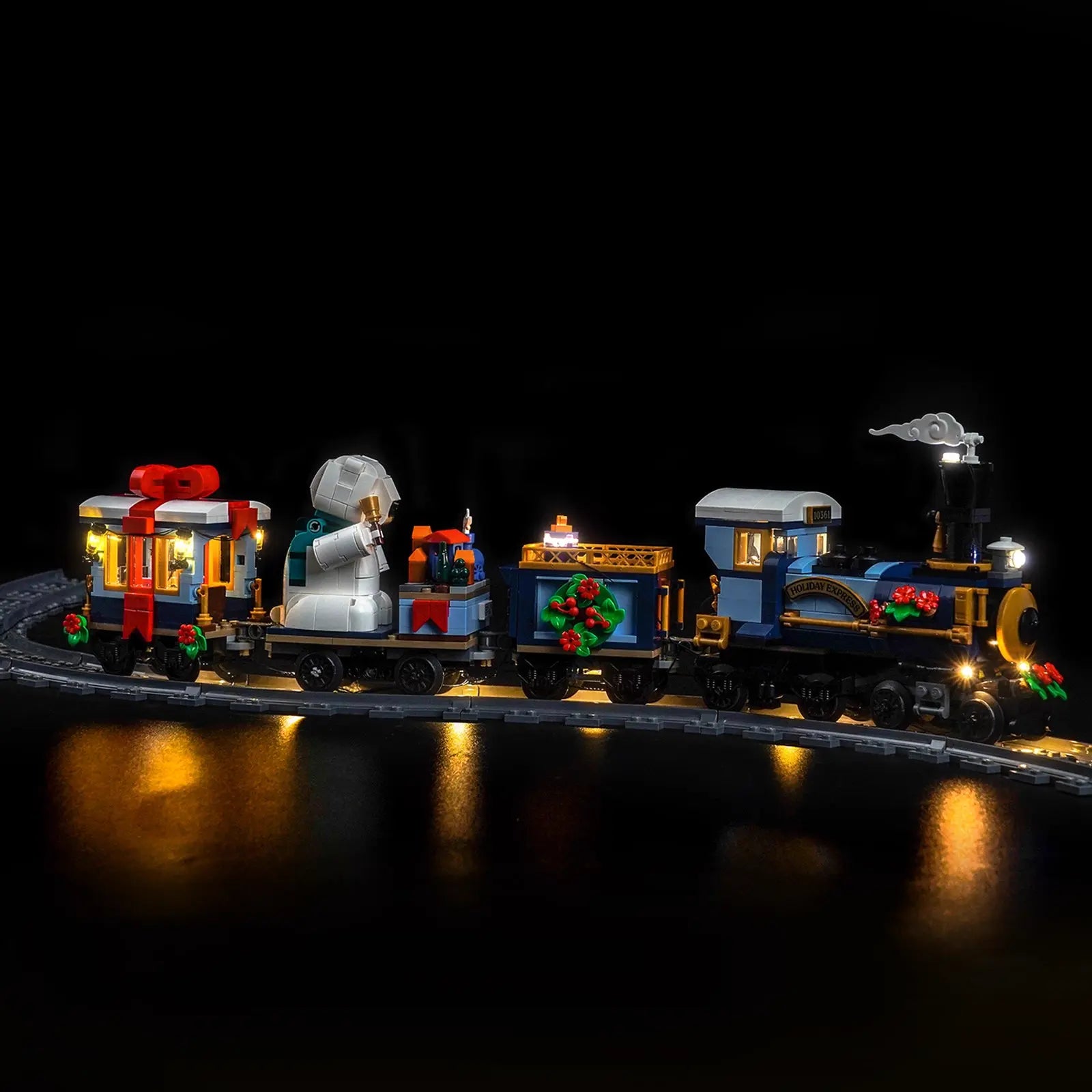 A magical nighttime shot of the fully illuminated LEGO Holiday Express Train, creating a perfect Christmas display.