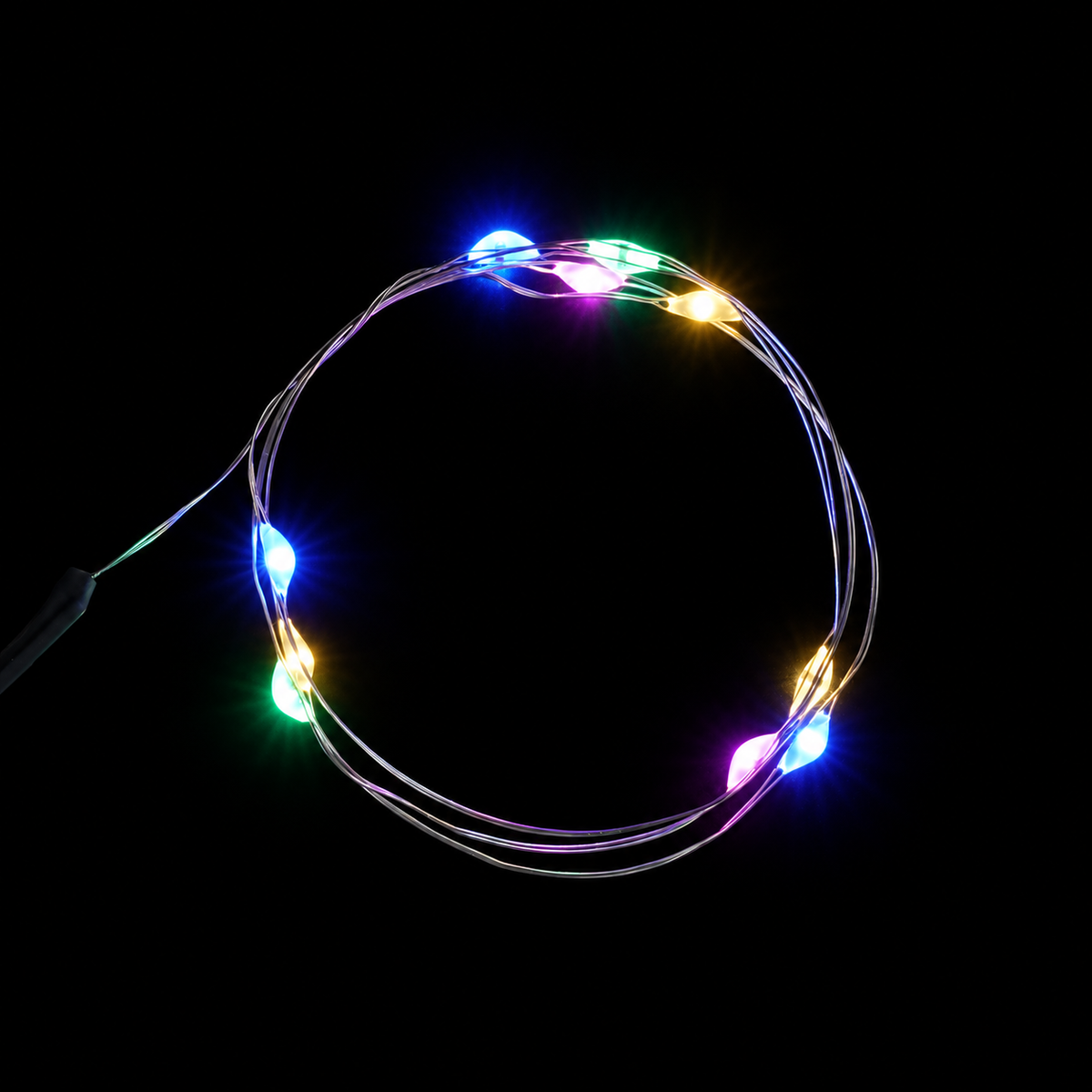 Four-colour LED string arranged in a loop on black background