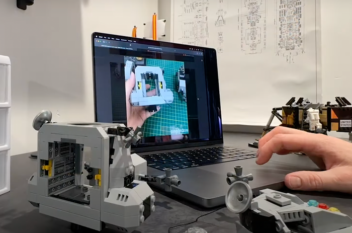 The digital manual open on a laptop beside the LEGO build