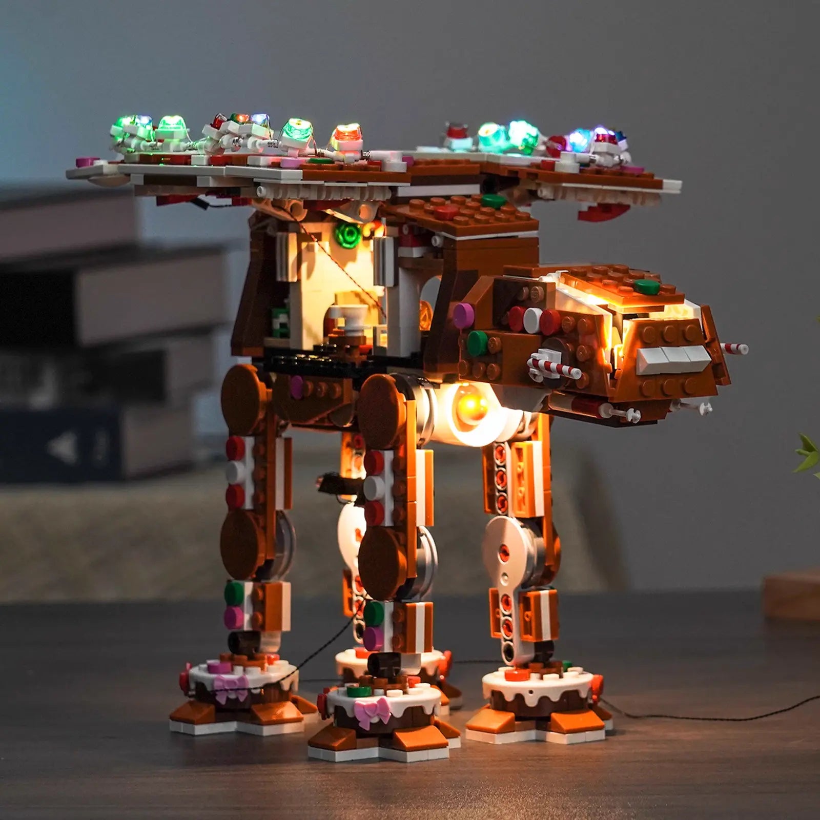 The included festive minifigure is highlighted by the warm lights from the LEGO Gingerbread AT-AT 40806 set.