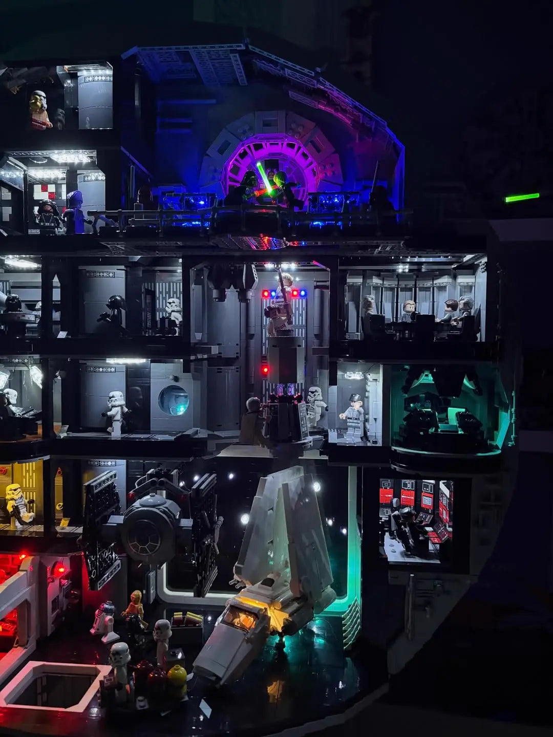 A detailed view of the cutaway interior of the LEGO Death Star 75419, showing all the illuminated rooms from our light kit.