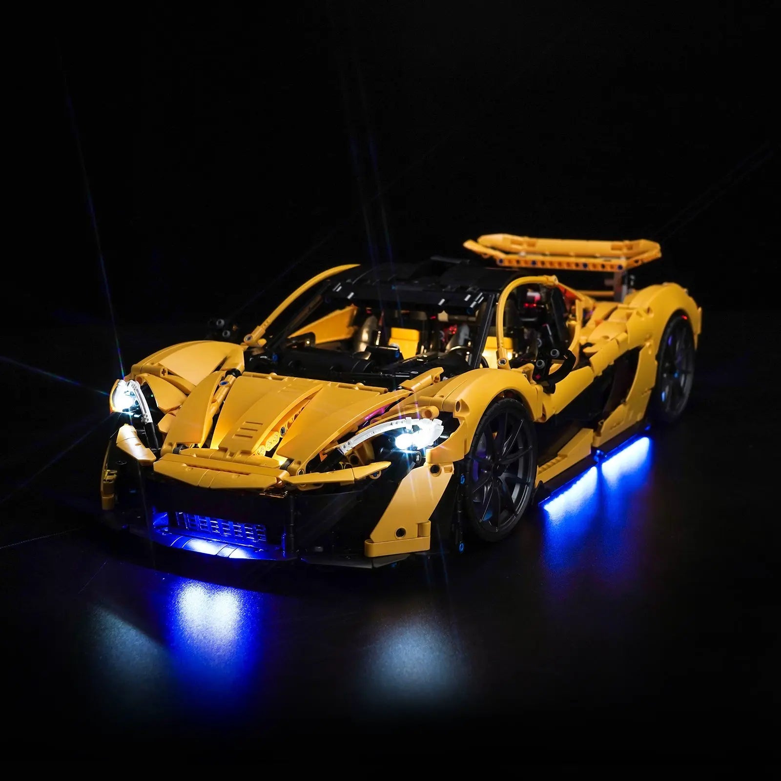The LEGO Technic McLaren P1 42172 transformed with a custom Bright My Bricks LED light kit illuminating its headlights.