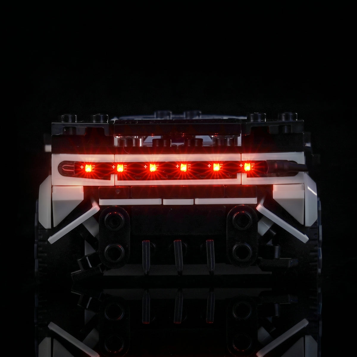 LEGO® Bugatti Centodieci Hyper Sports Car #77240 illuminated at night, with the LED lights