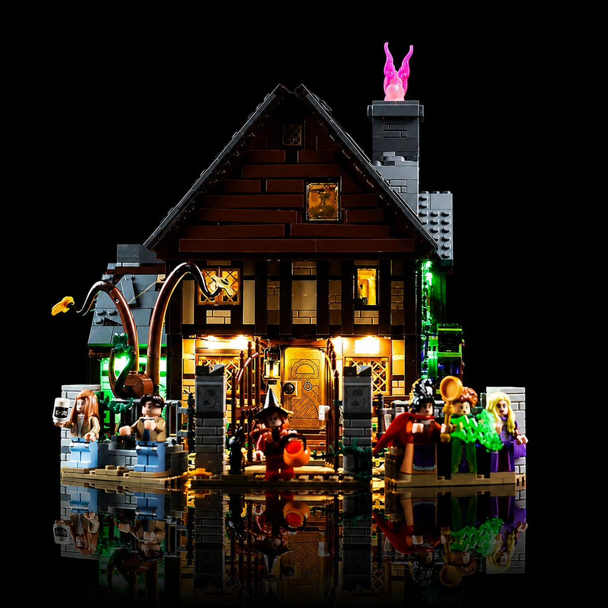 LEGO® Disney Hocus Pocus: The Sanderson Sisters' Cottage #21341 — side angle with lights on (LED lighting kit)