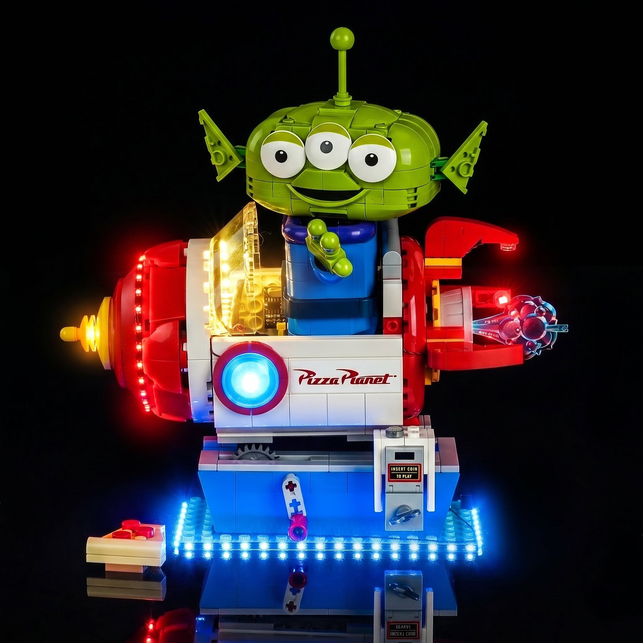 LEGO® Disney Toy Story Alien with Pizza Planet Rocket Ride #43307 front view fully lit, with the LED lights