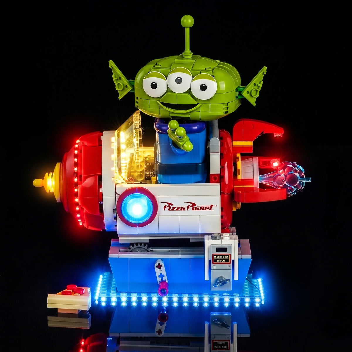 LEGO® Disney Toy Story Alien with Pizza Planet Rocket Ride #43307 front view fully lit, with the LED lights