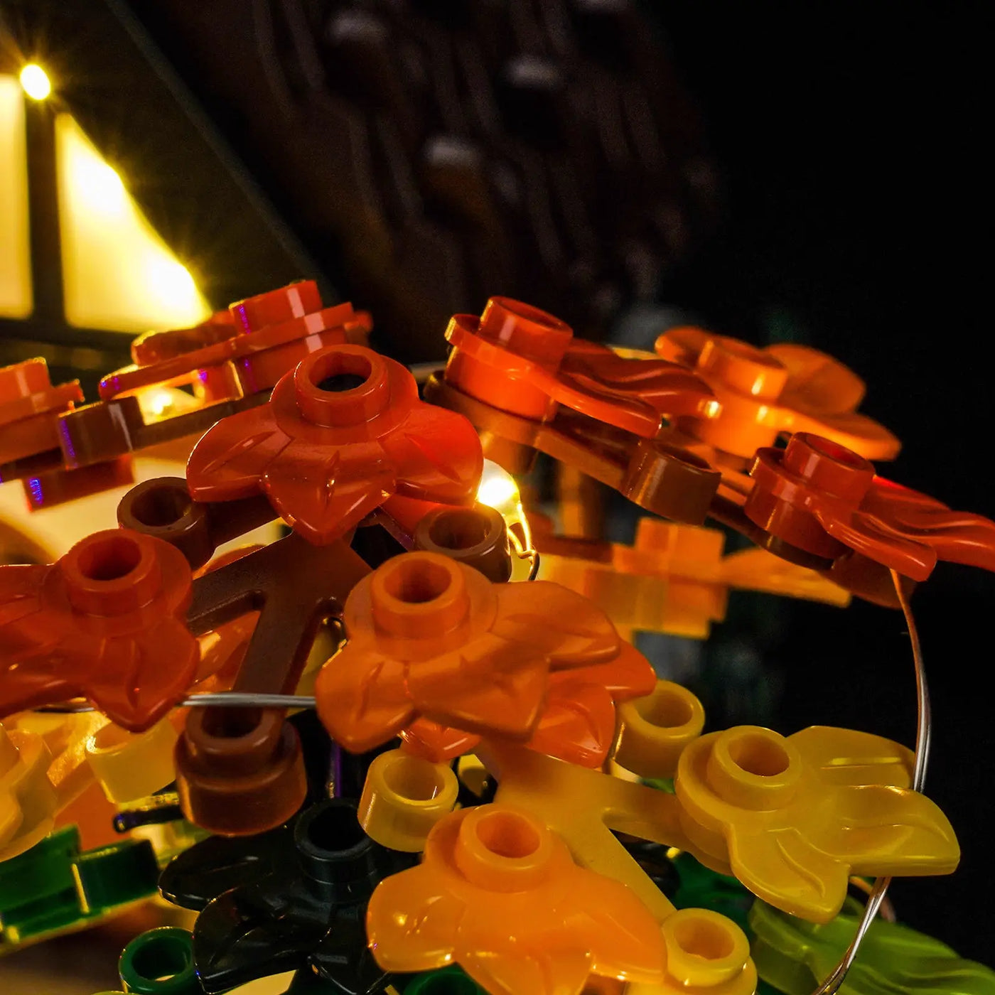 LEGO® Icons Autumn Cottage Garden #11372 side angle with lights on, with the DIY LED light kit