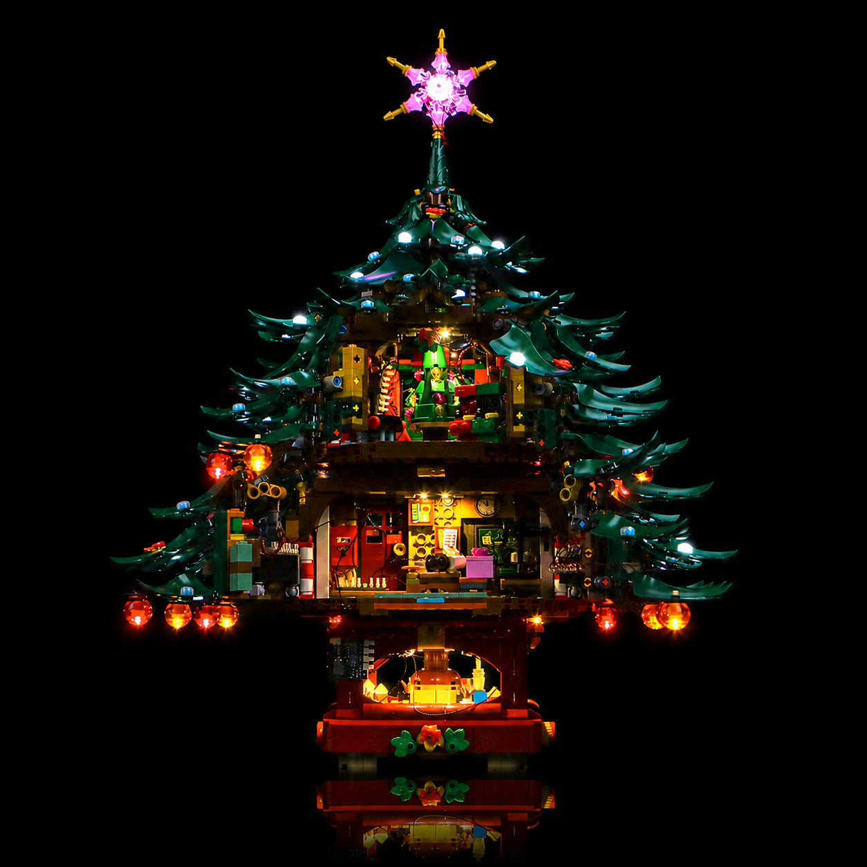 LEGO® Icons Family Christmas Tree #41843 illuminated at night, with the RGB LED light kit