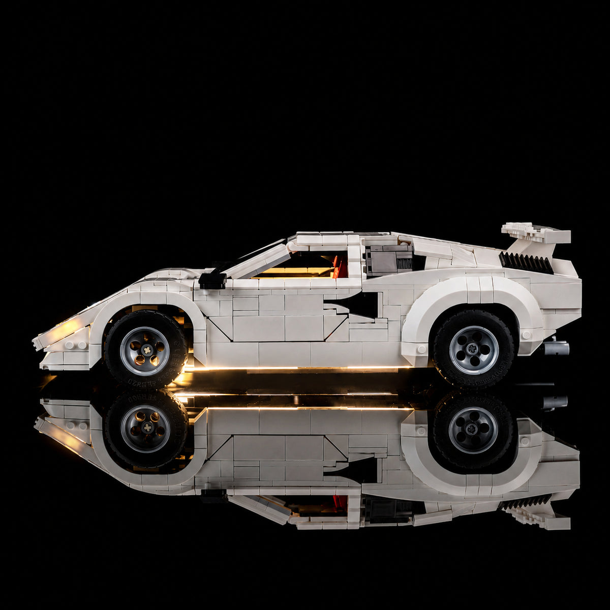 LEGO® Icons Lamborghini Countach #5000 side angle with lights on, with the LED lights