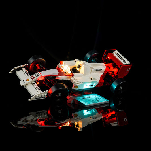 LEGO® Icons McLaren MP4/4 & Ayrton Senna #10330 fully illuminated on display, with the premium LED light kit