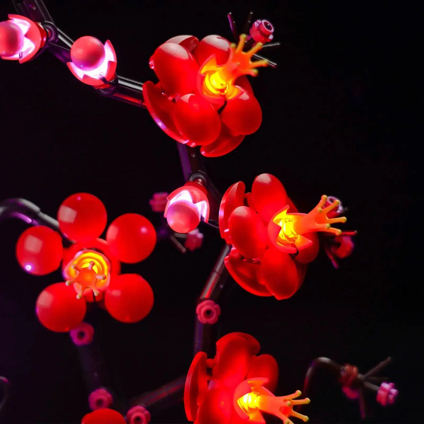 LEGO® Icons Plum Blossom #10369 illuminated at night, with the LED lights