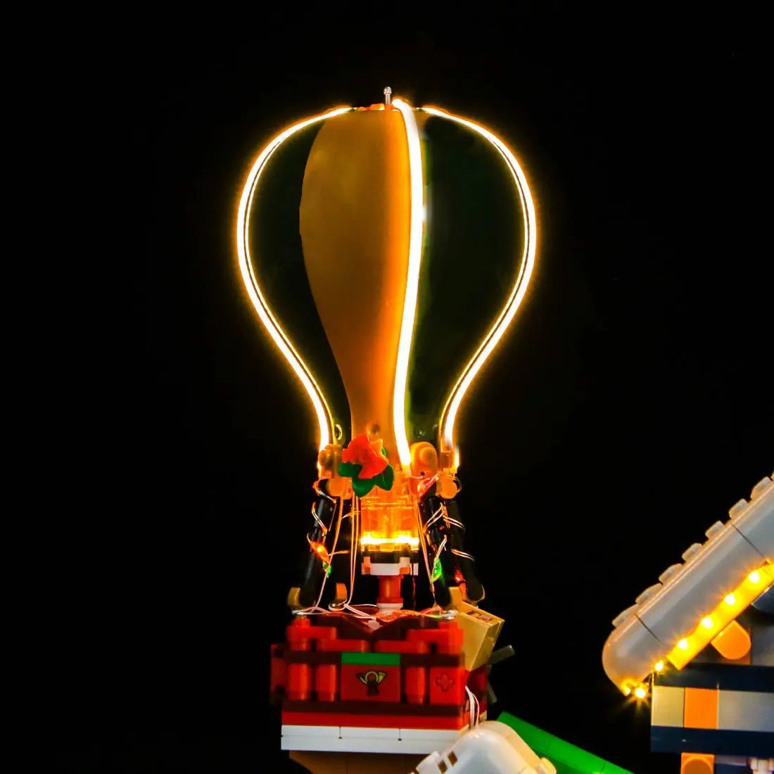 LEGO® Icons Santa's Post Office #10339 side angle with lights on, with the LED lights