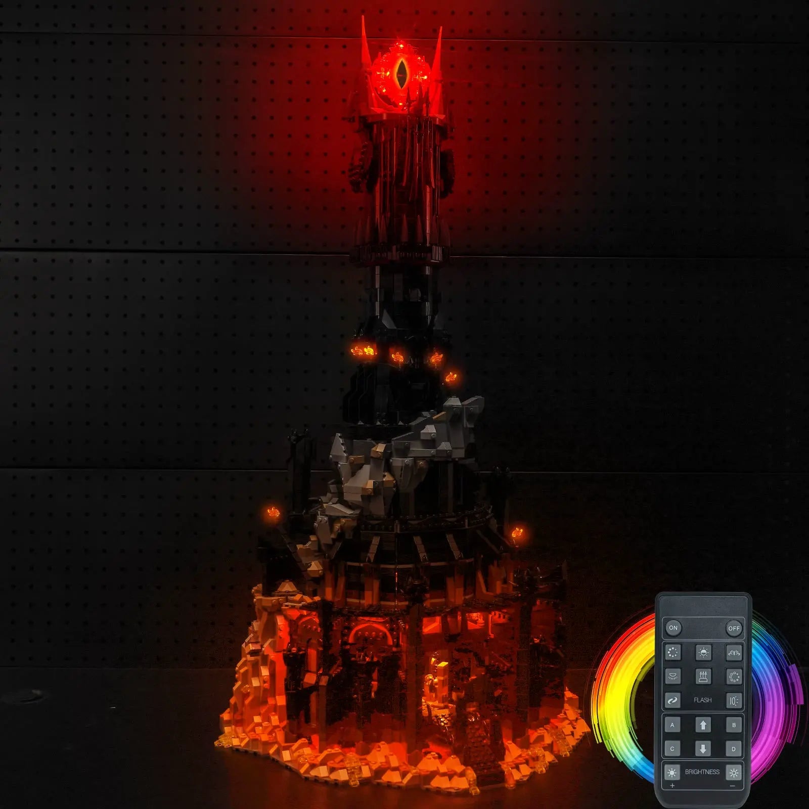 The massive LEGO Icons Barad-dûr 10333 tower, fully illuminated with a menacing, fiery glow by Bright My Bricks.