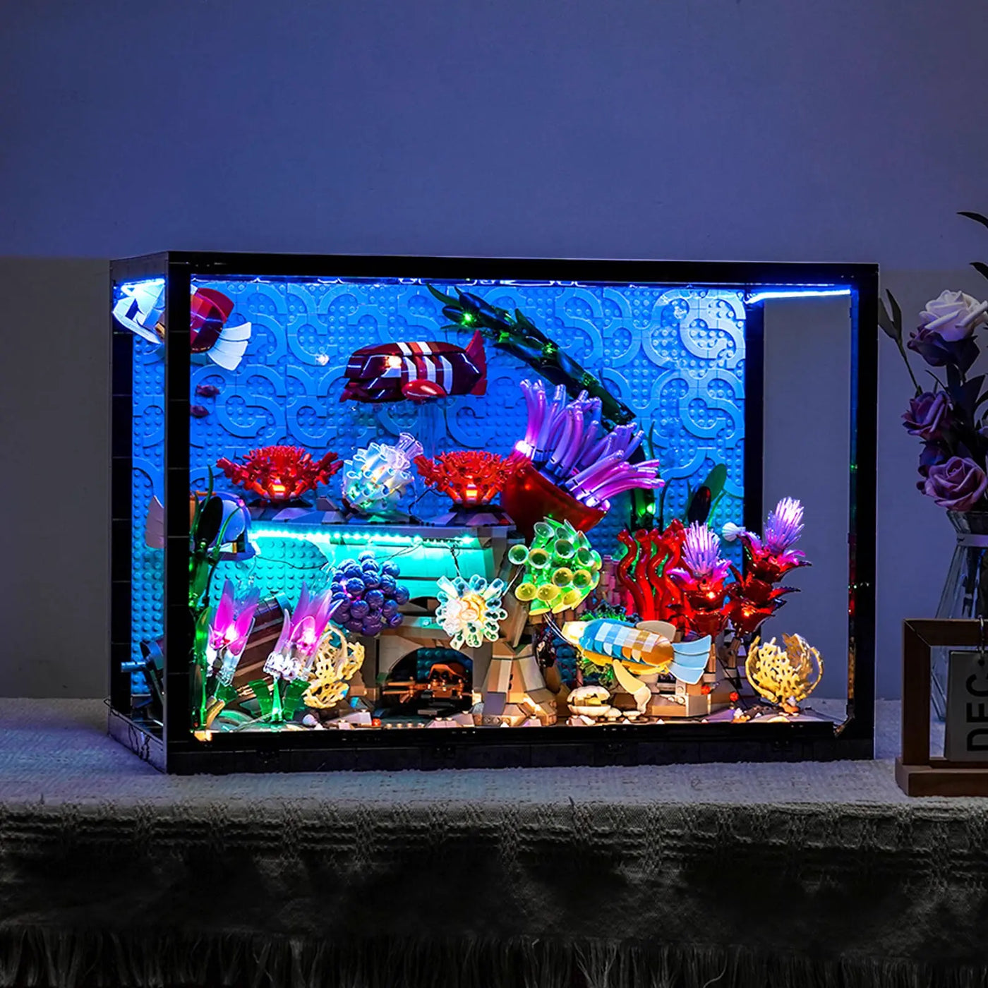 LEGO® Icons Tropical Aquarium #10366 fully illuminated on display, with the custom LED lighting