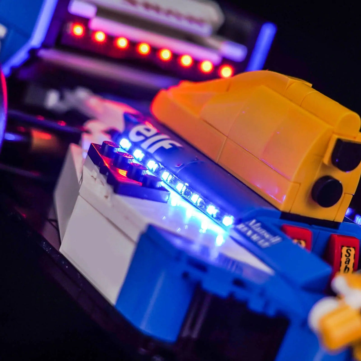 LEGO® Icons Williams Racing FW14B & Nigel Mansell #10353 side angle with lights on, with the USB-powered LED light kit