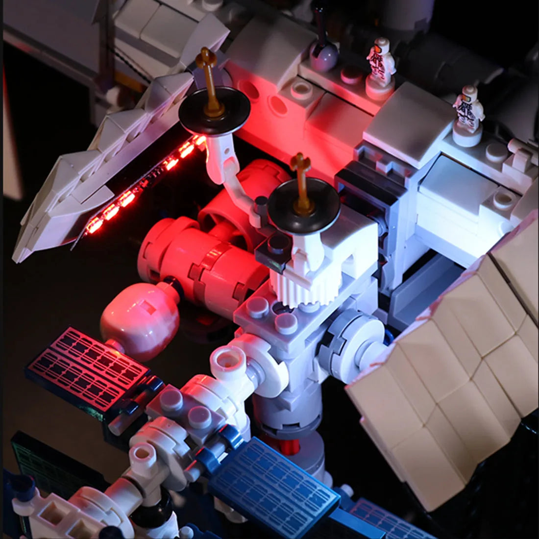 LEGO® Ideas International Space Station #21321 fully illuminated on display, with the light kit