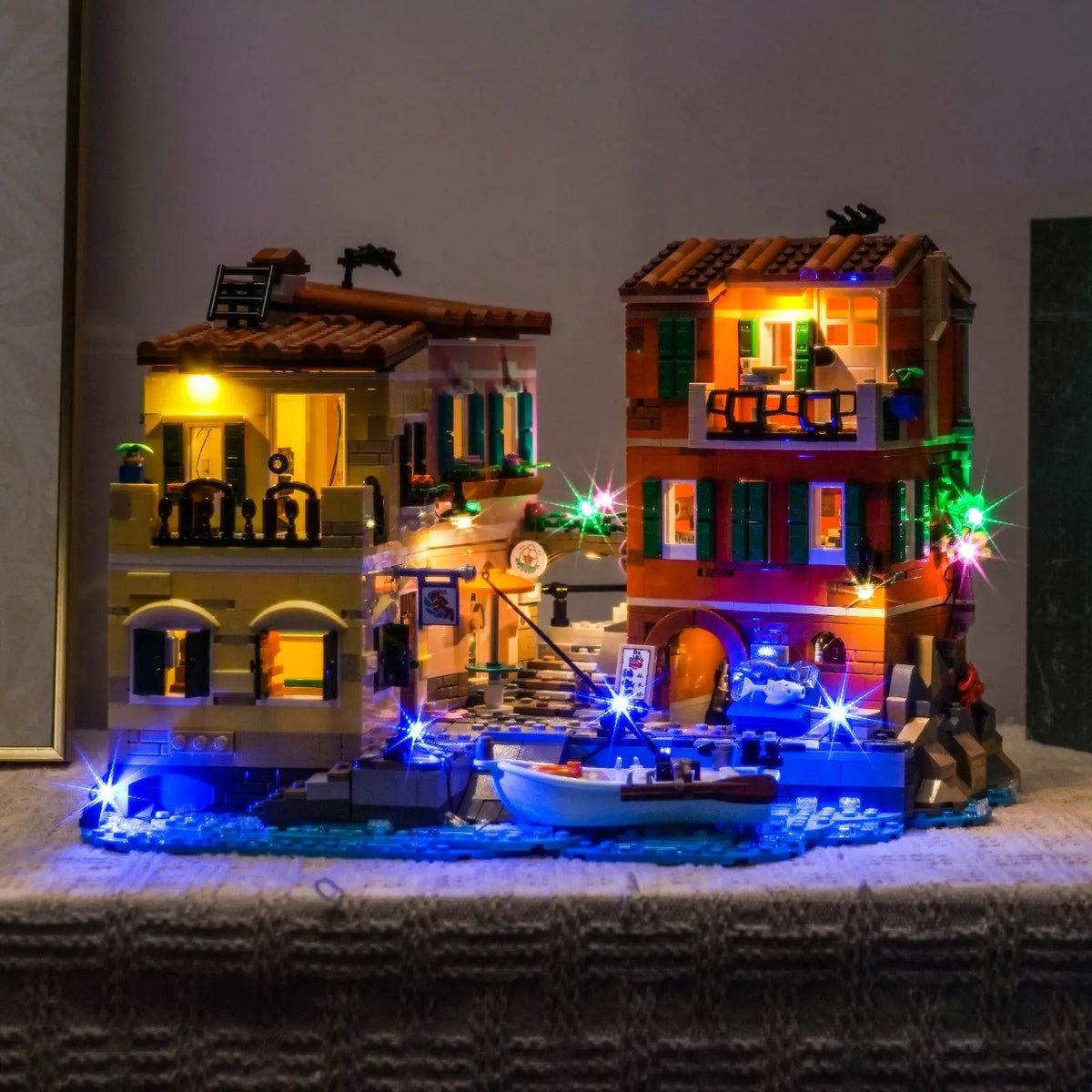 LEGO® Ideas Italian Riviera #21359 illuminated at night, with the LED lights