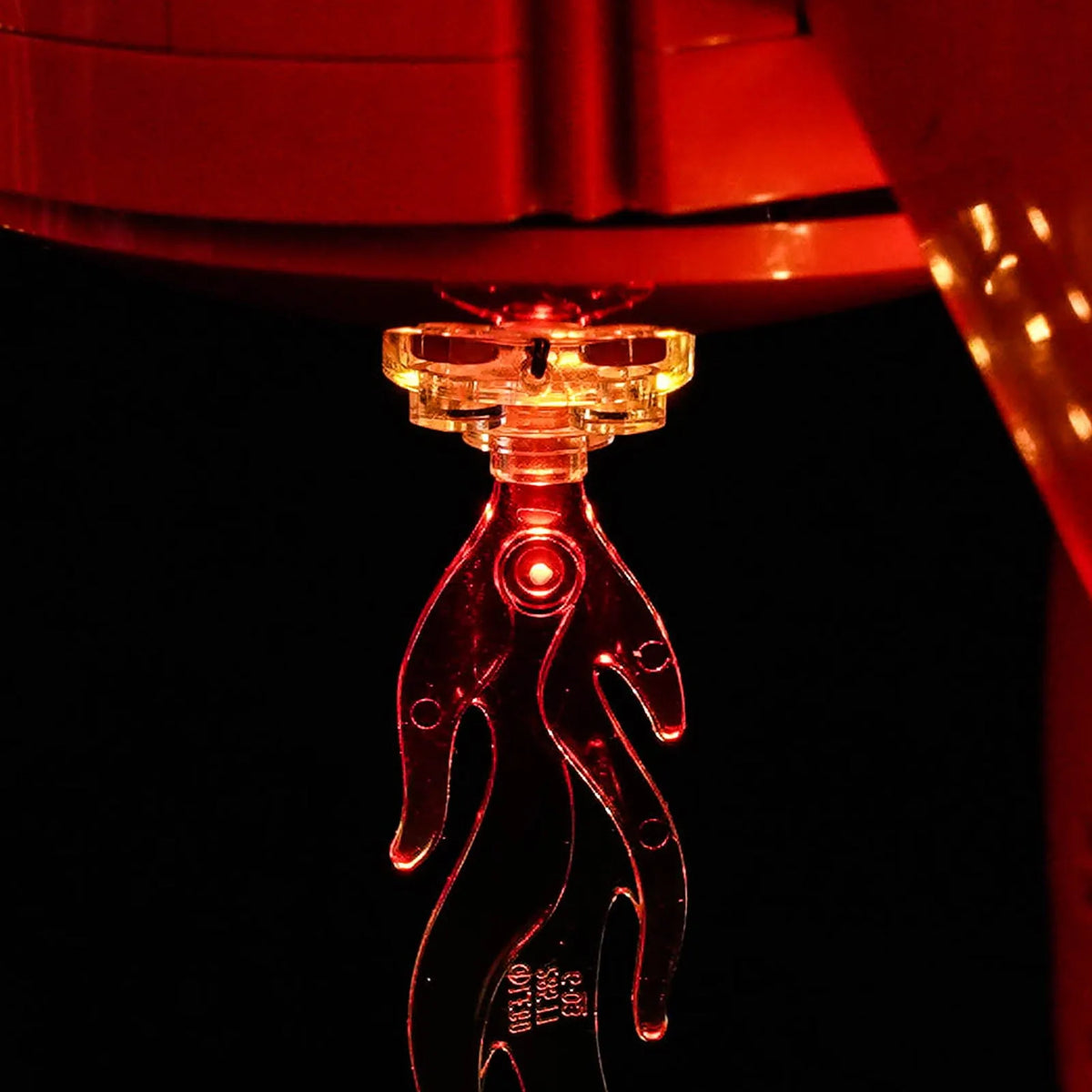 LEGO® Ideas Tintin Moon Rocket #21367 fully illuminated on display, with the display light kit