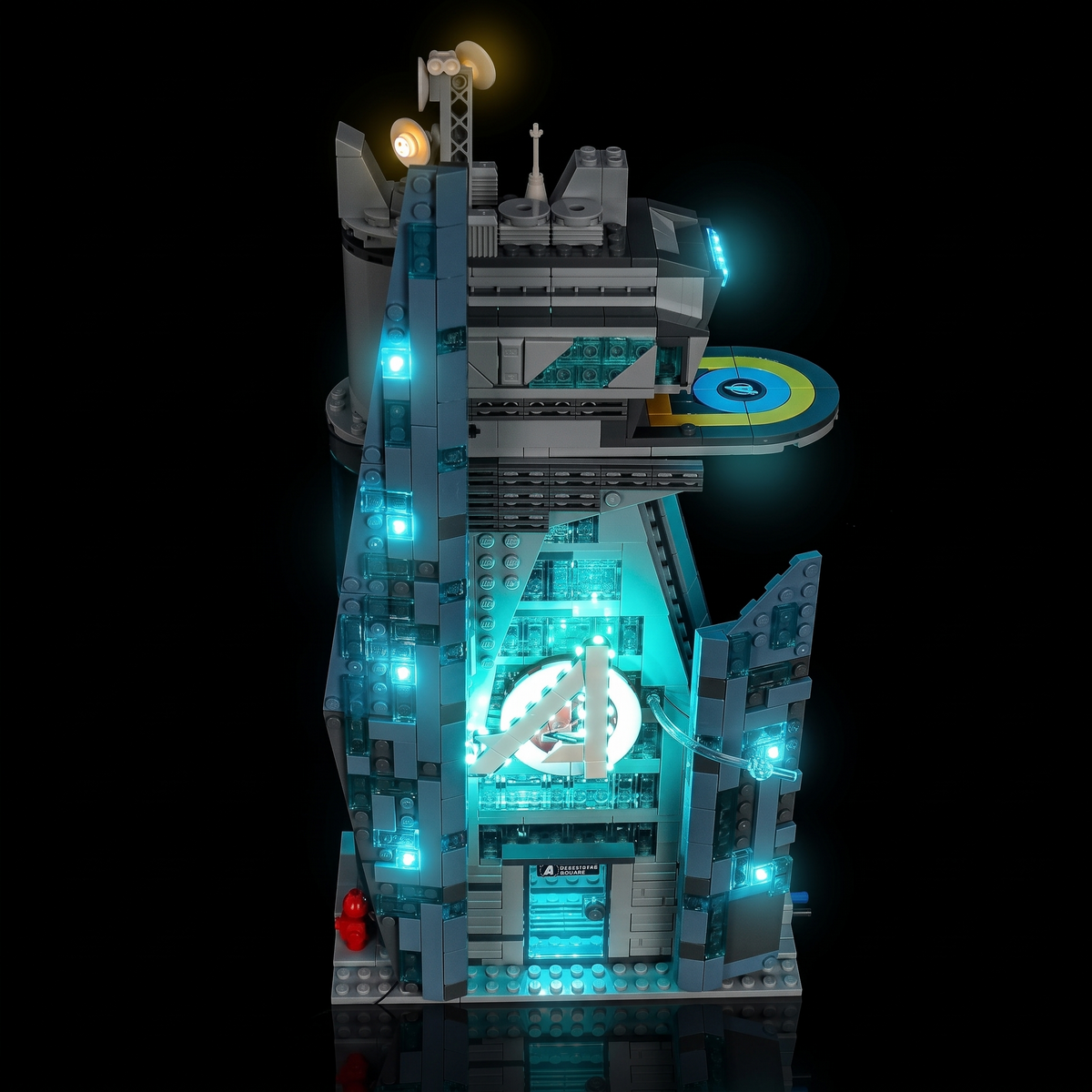 Right-front view of the illuminated LEGO® New Avengers Tower #76352 with blue floor lighting