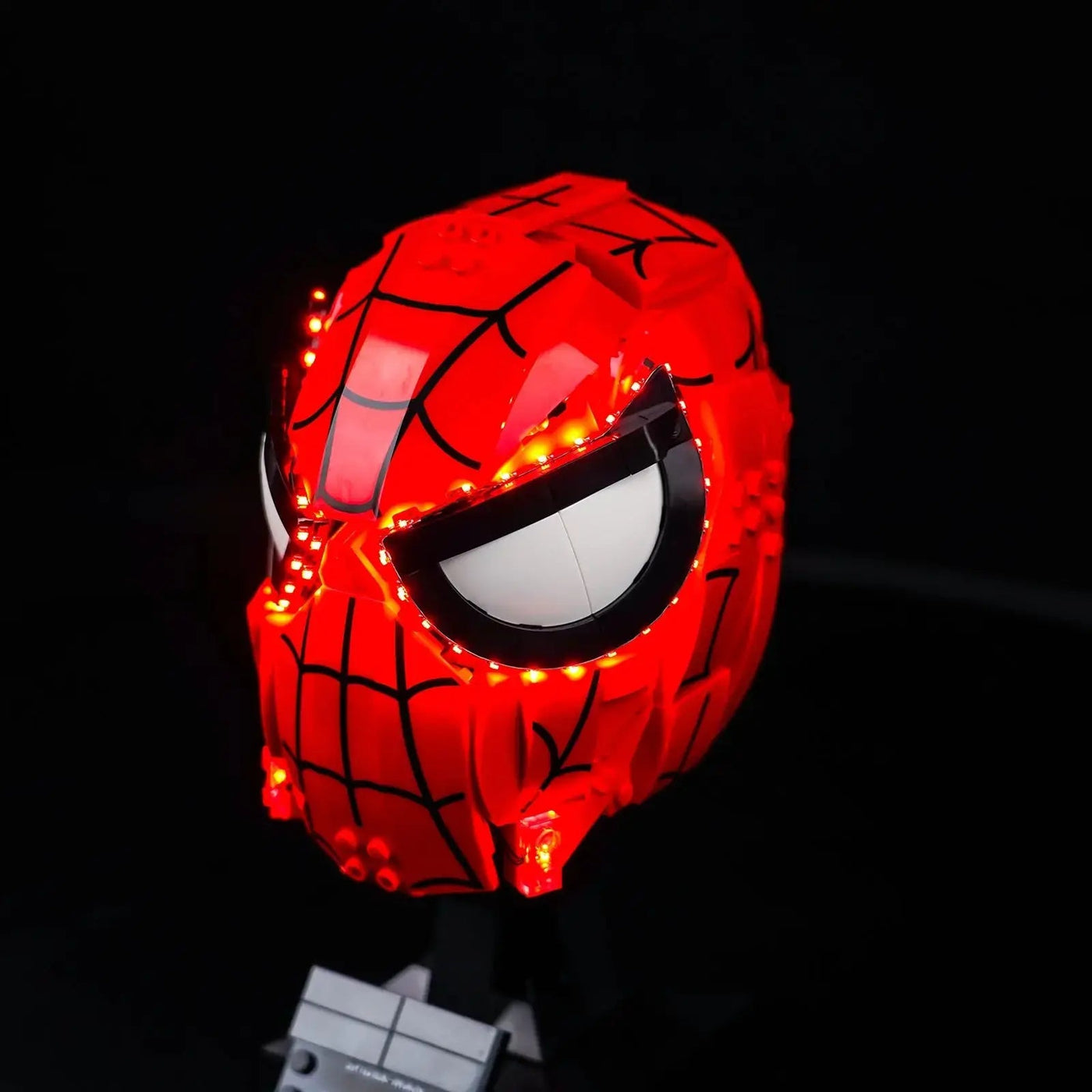 DIY LED light kit for LEGO® Marvel Spider-Man's Mask #76285, fully illuminated on display