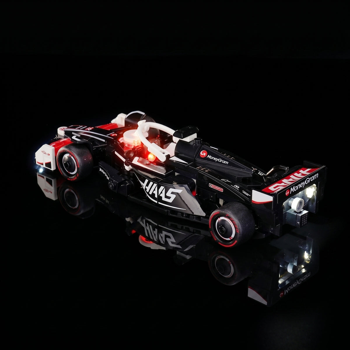 LEGO® MoneyGram Haas F1 Team VF-24 Race Car #77250 illuminated at night, with the USB-powered LED light kit