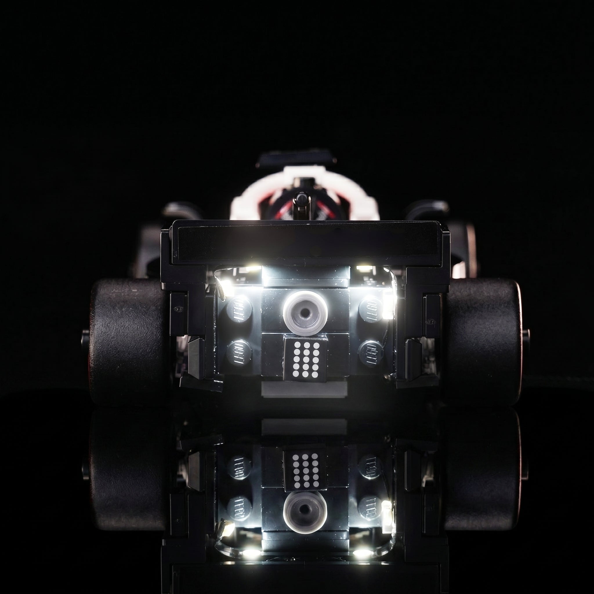 LEGO® MoneyGram Haas F1 Team VF-24 Race Car #77250 illuminated at night, with the premium LED light kit