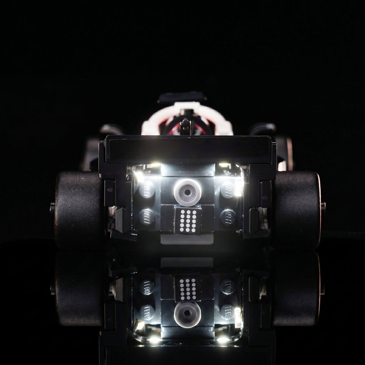 LEGO® MoneyGram Haas F1 Team VF-24 Race Car #77250 illuminated at night, with the premium LED light kit