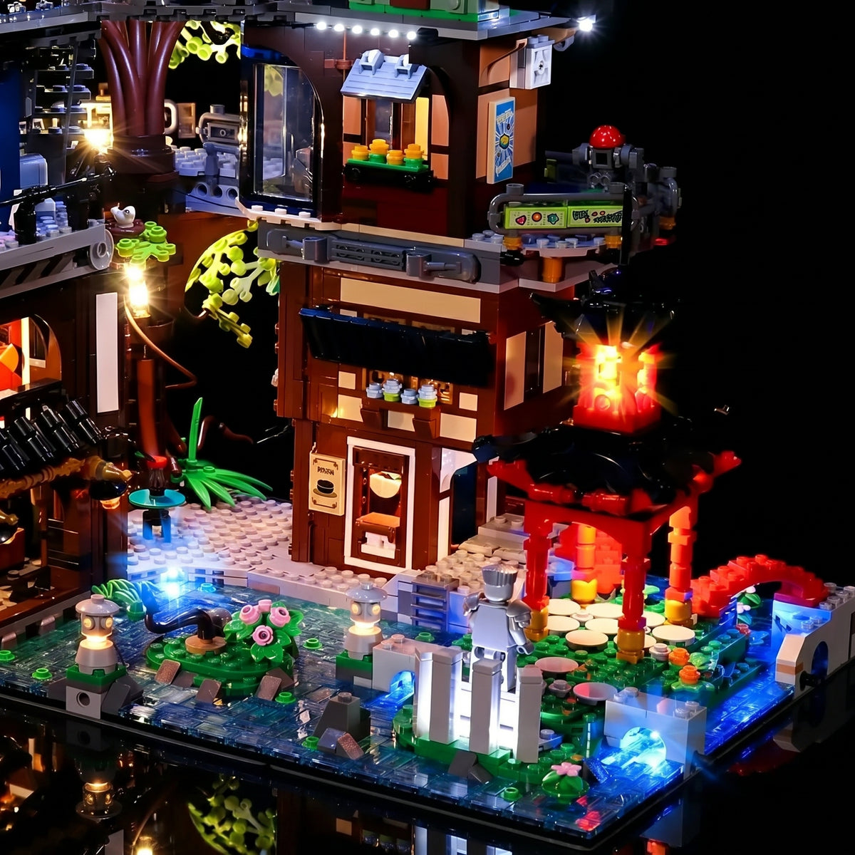 LEGO® NINJAGO City Gardens #71741 fully illuminated on display, with the custom LED lighting