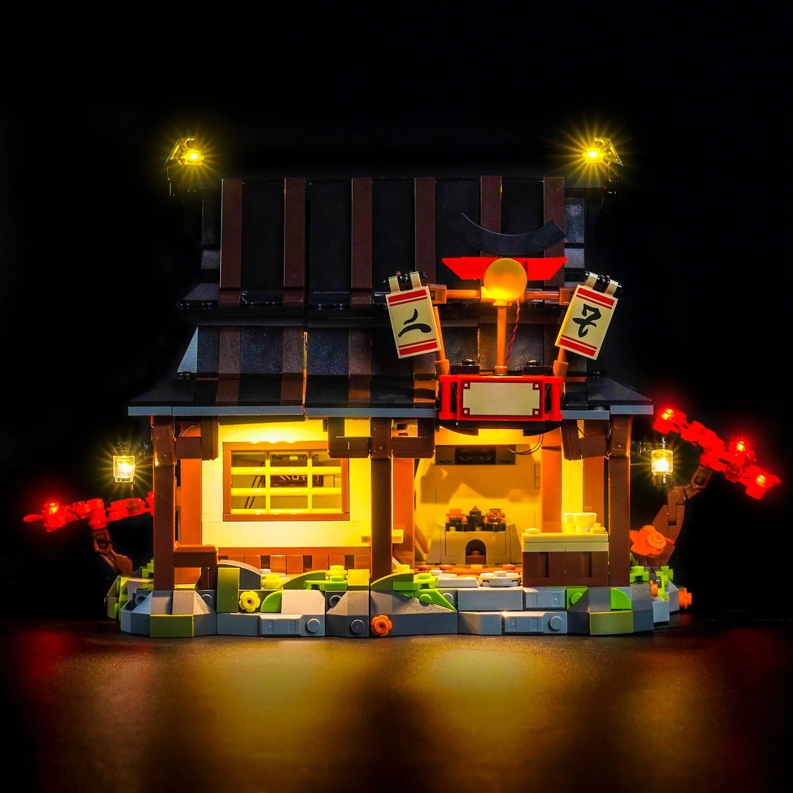 LEGO® Ninjago Four Weapons Blacksmith 15th Anniversary #71858 showcase lighting view, with the premium LED light kit