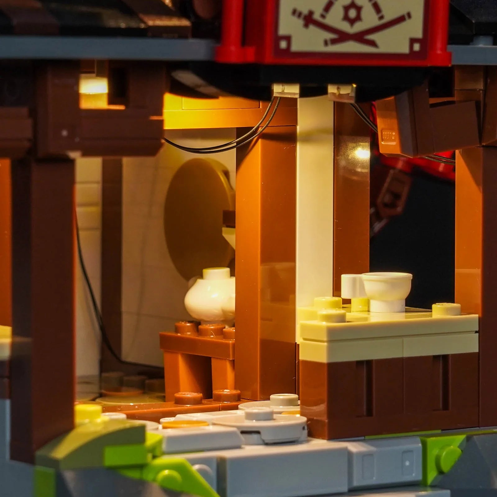 LED light kit for LEGO® Ninjago Four Weapons Blacksmith 15th Anniversary #71858, fully illuminated on display