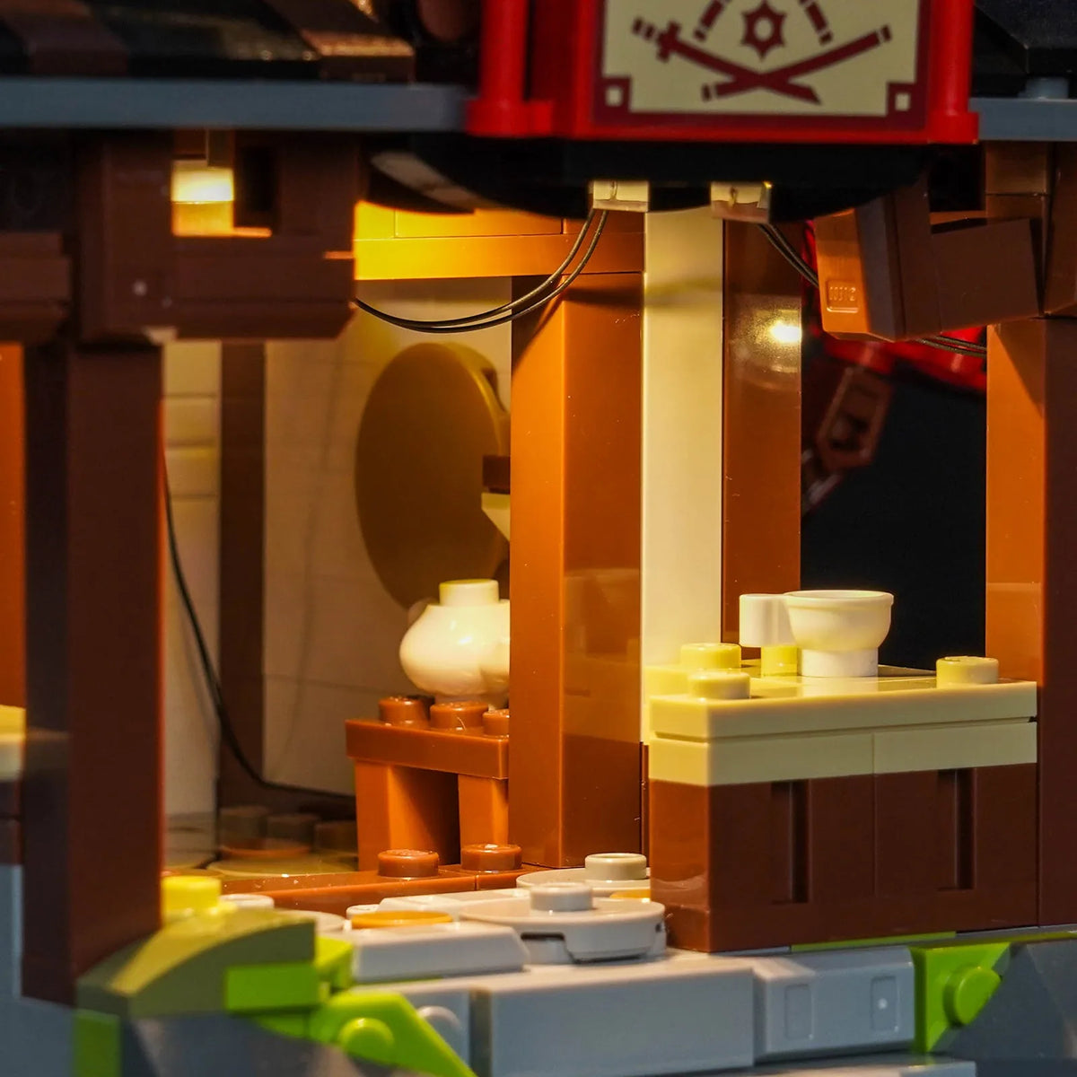 LED light kit for LEGO® Ninjago Four Weapons Blacksmith 15th Anniversary #71858, fully illuminated on display