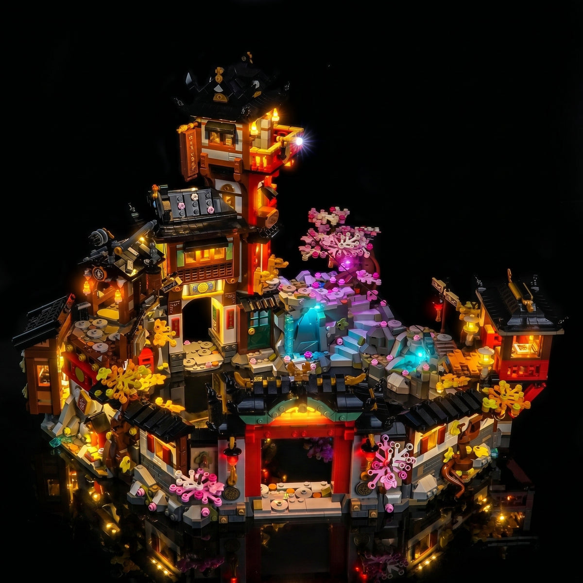 LEGO® NINJAGO The Old Town 15th Anniversary #71861 illuminated at night, with the display light kit