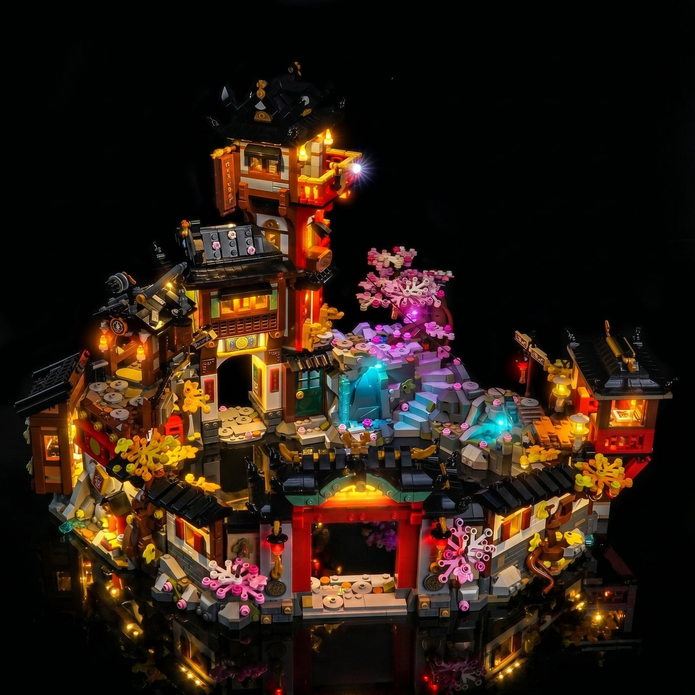 LEGO® NINJAGO The Old Town 15th Anniversary #71861 illuminated at night, with the display light kit