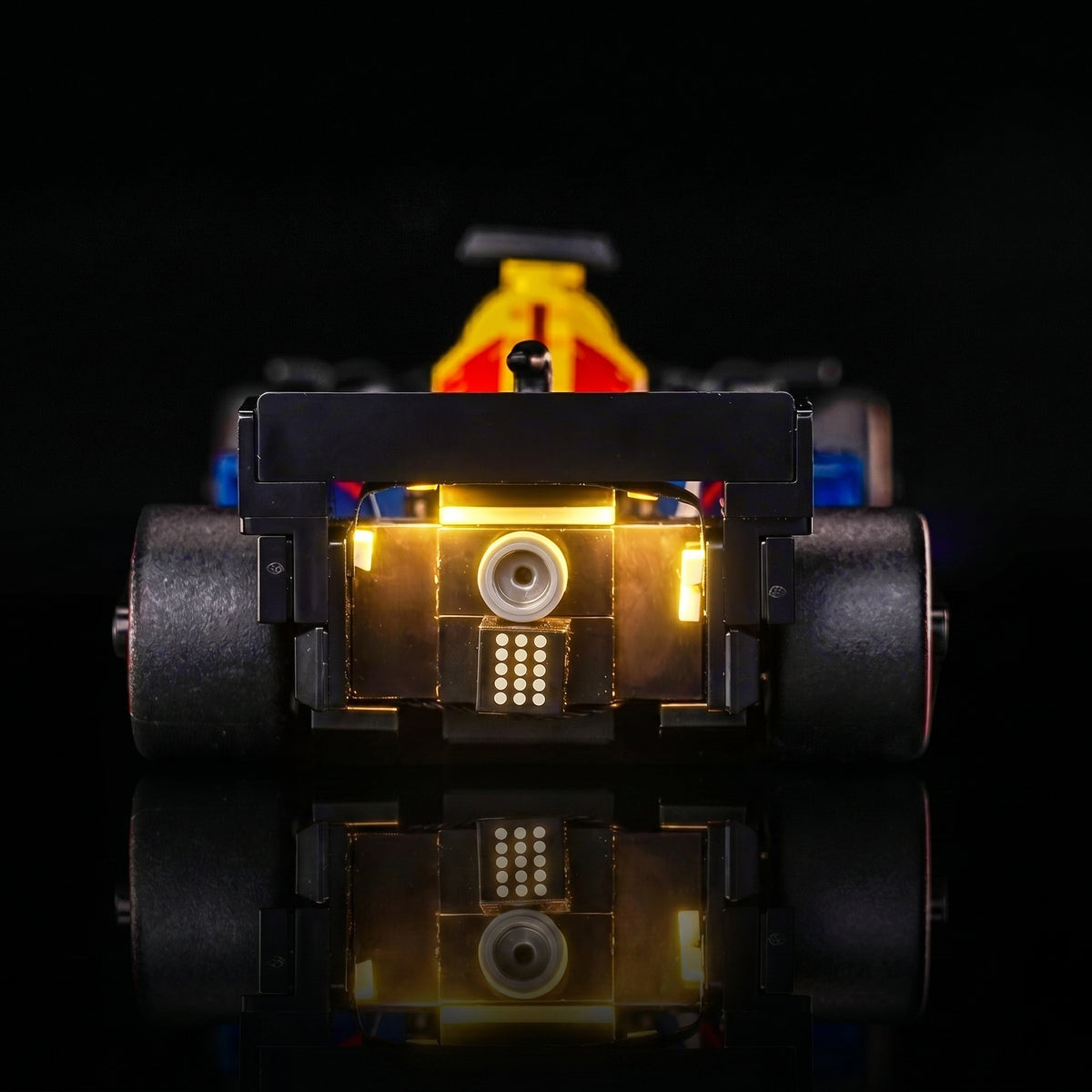 LEGO® Oracle Red Bull Racing RB20 F1 Race Car #77243 fully illuminated on display, with the premium LED light kit