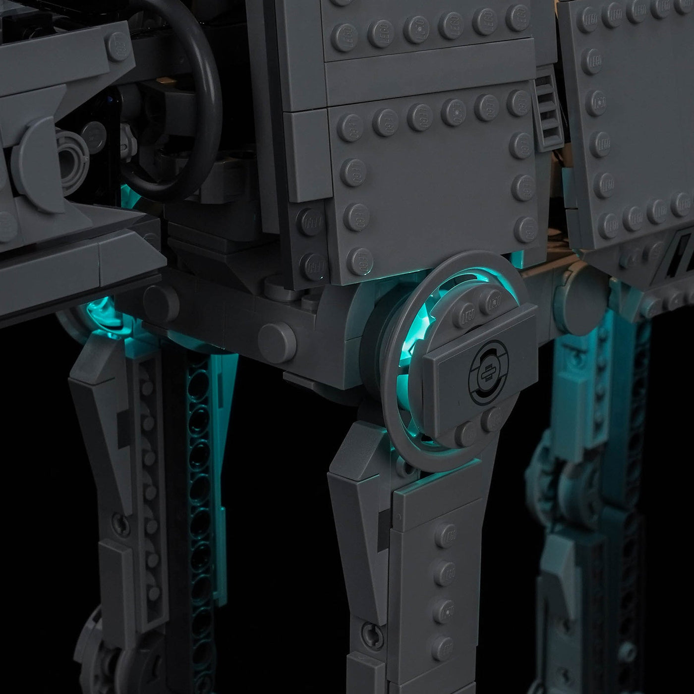 Close-up of the hip joints of LEGO Imperial Remnant AT-AT 75454 lit cyan by the Bright My Bricks kit