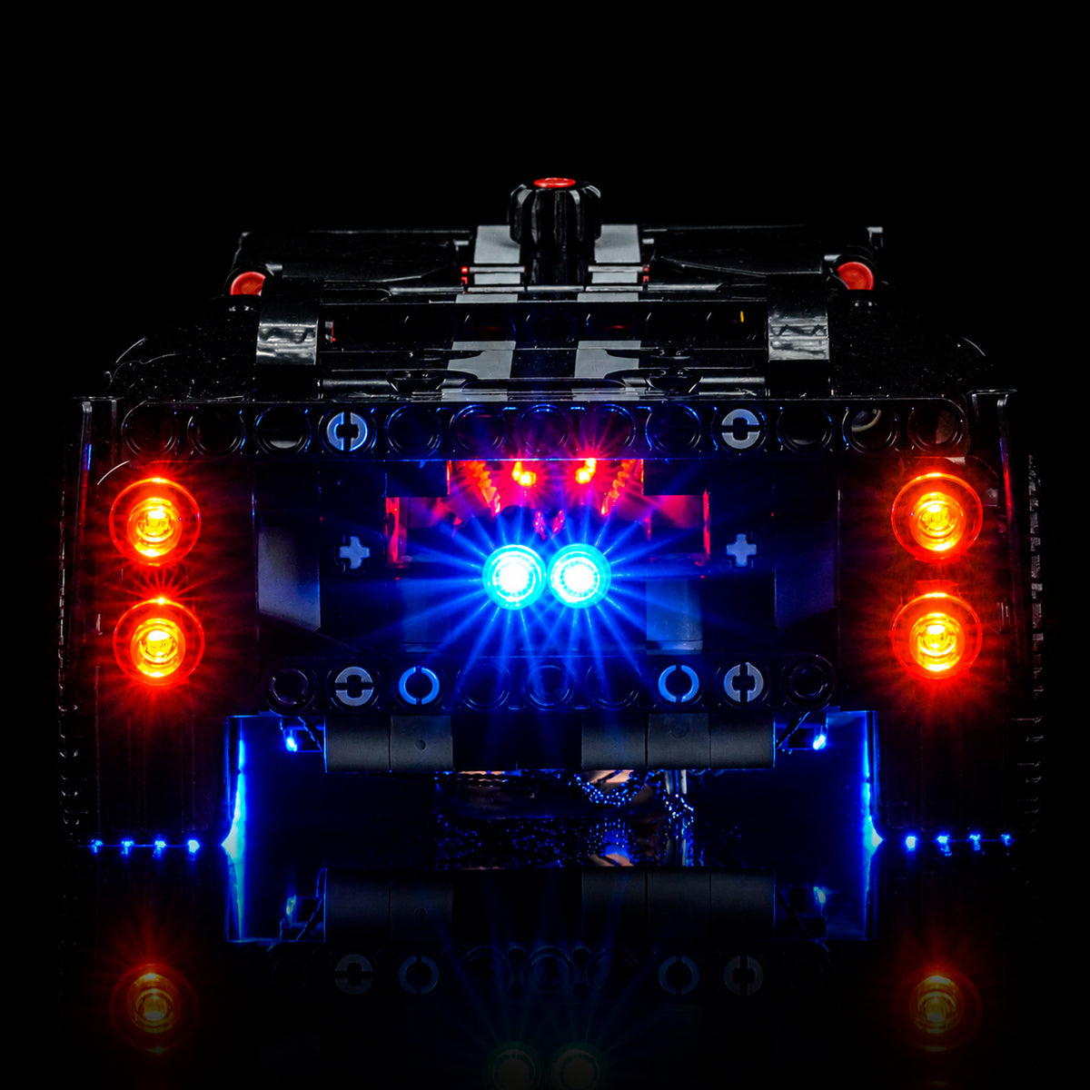 LEGO® Technic 1966 Ford GT40 MKII Race Car #42223 illuminated at night, with the RGB LED light kit