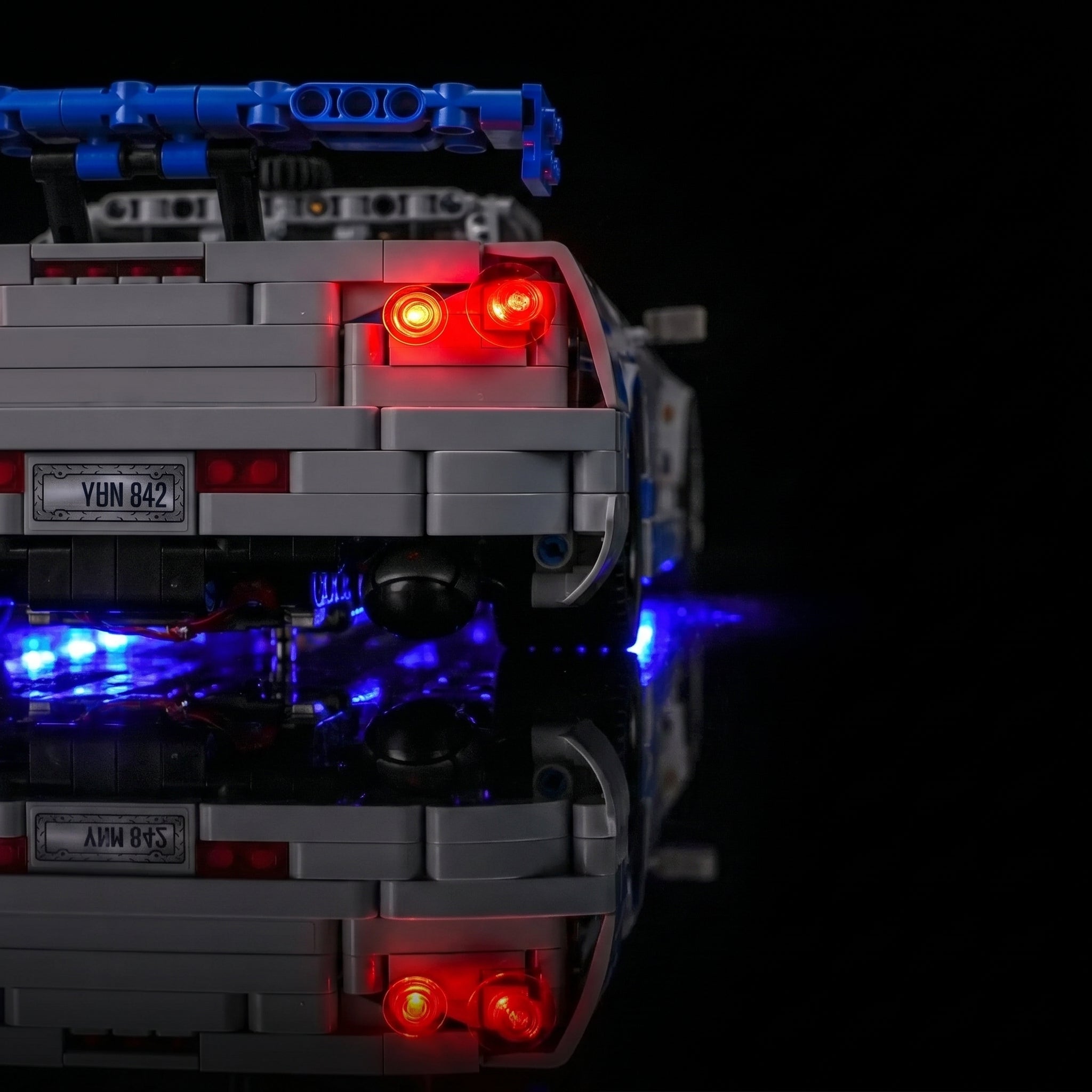 LEGO® Technic 2 Fast 2 Furious Nissan Skyline GT-R (R34) #42210 fully illuminated on display, with the custom LED lighting