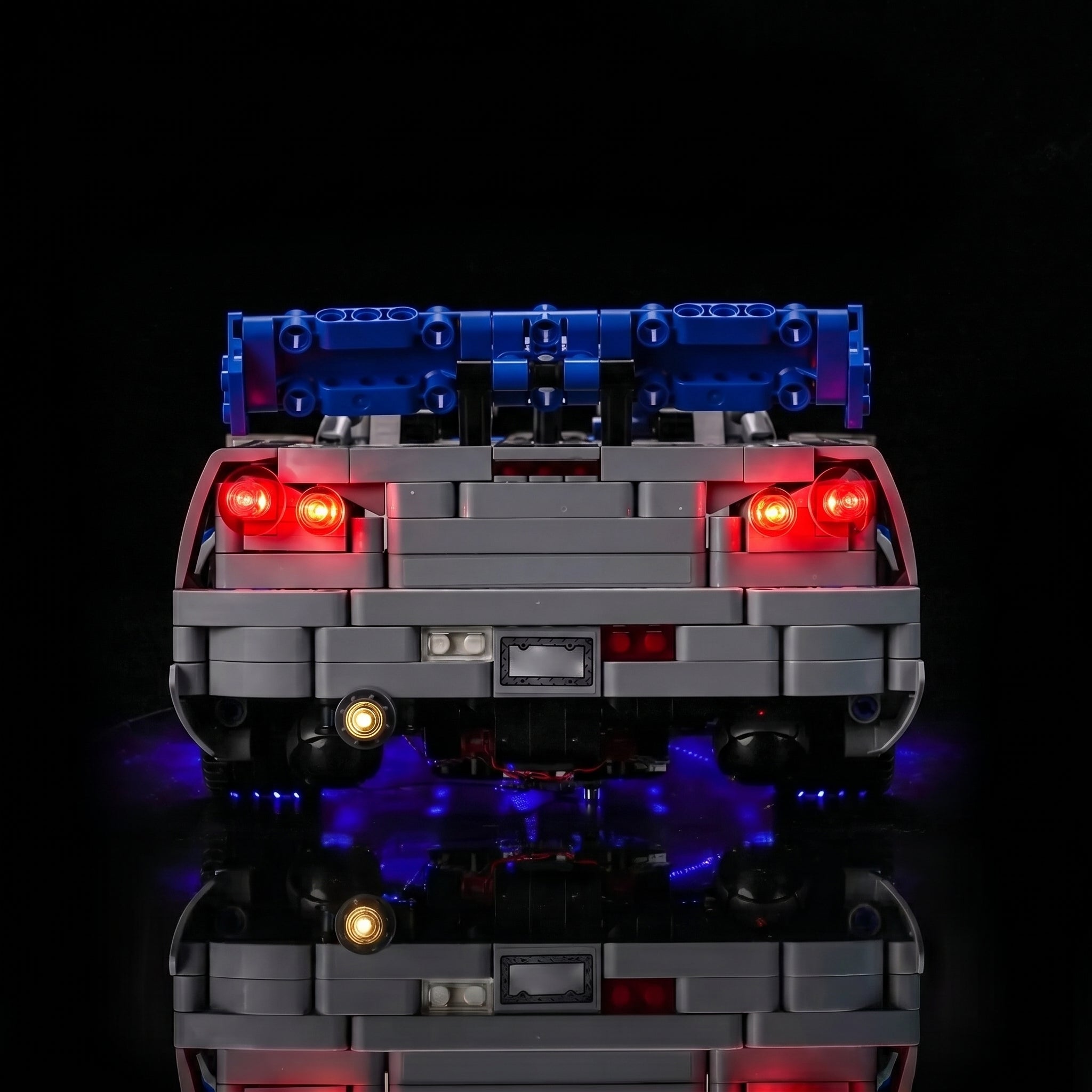LEGO® Technic 2 Fast 2 Furious Nissan Skyline GT-R (R34) #42210 display lighting in a dark room, with the RGB LED light kit