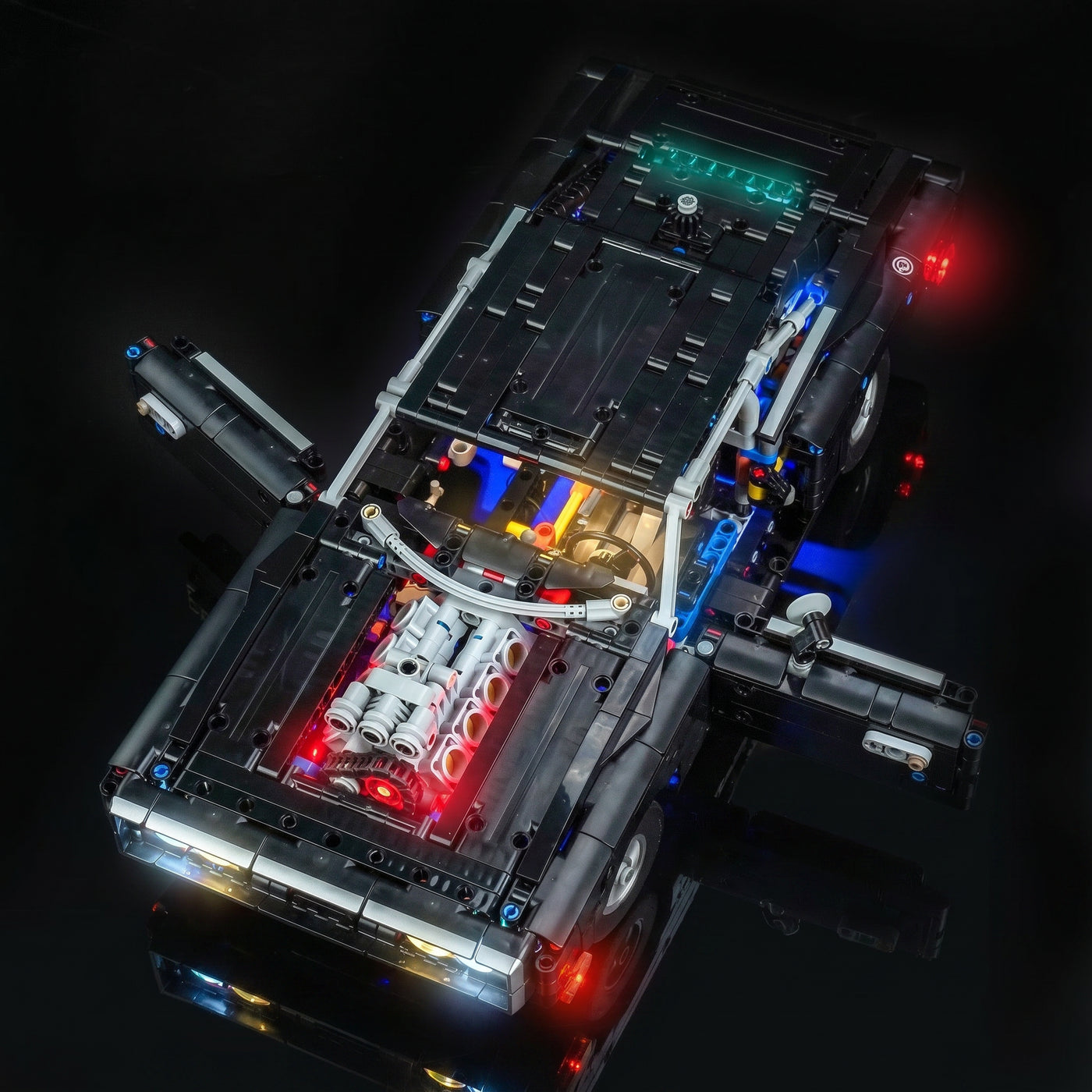 LEGO® Technic Fast and Furious Dodge Charger R/T #42231 — side angle with lights on (USB-powered LED light kit)