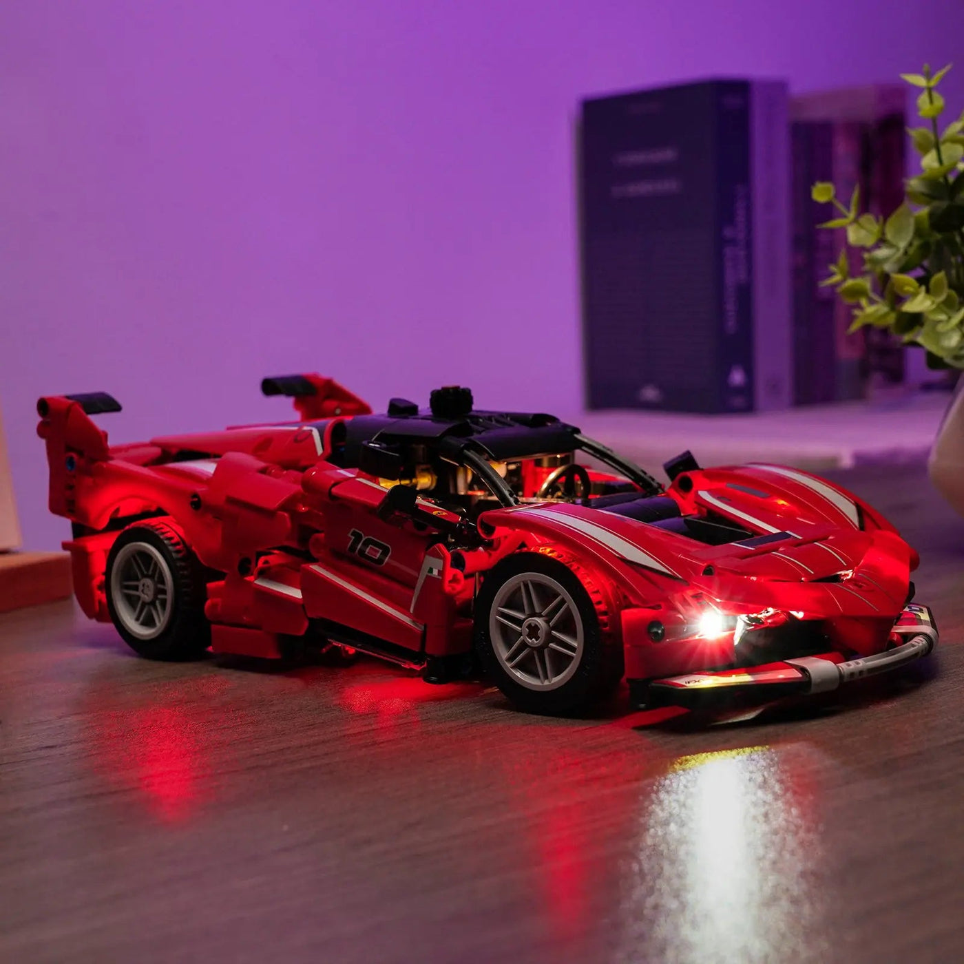 LEGO® Technic Ferrari FXX K #42212 fully illuminated on display, with the premium LED light kit