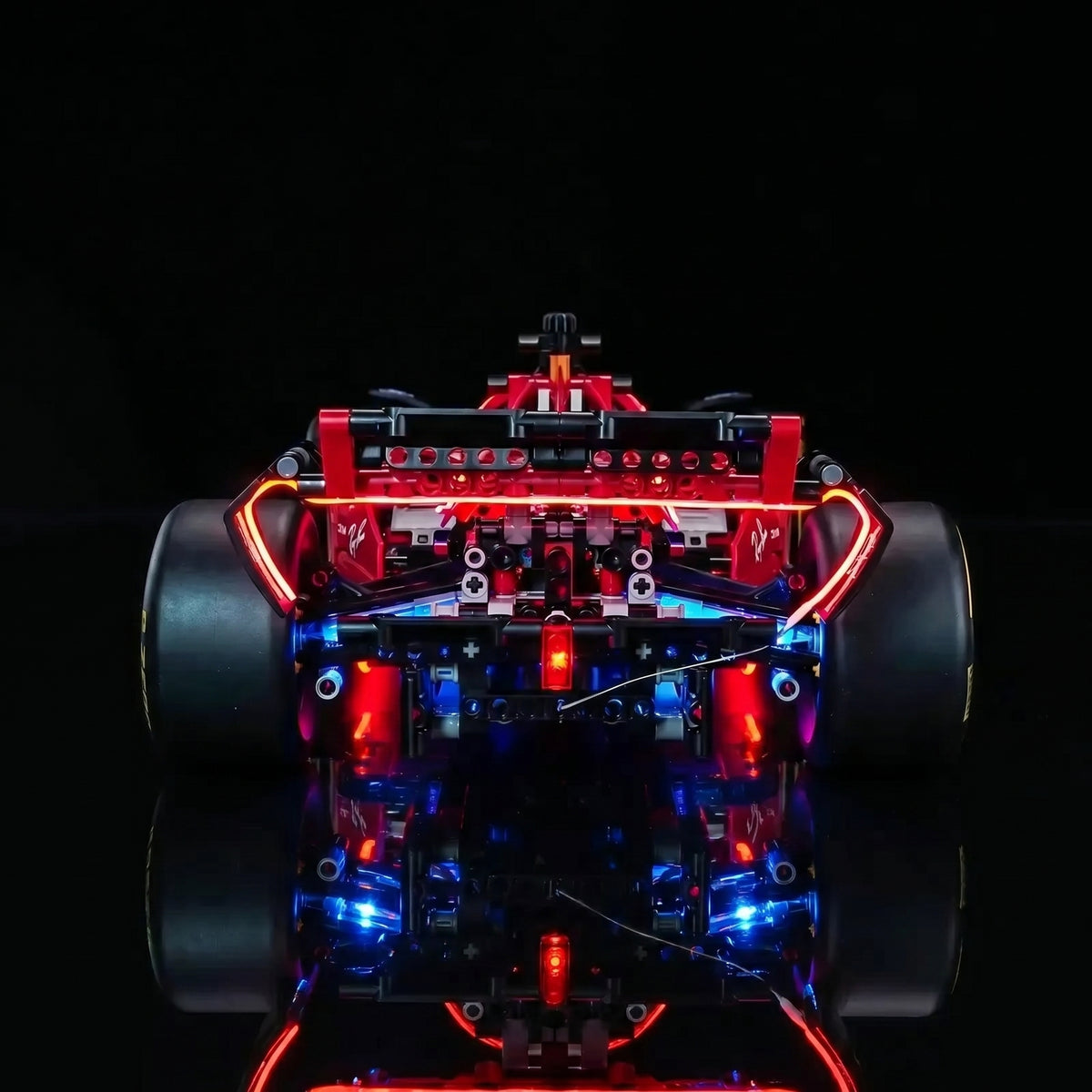 LEGO® Technic Ferrari SF-24 F1 Car #42207 fully illuminated on display, with the display light kit