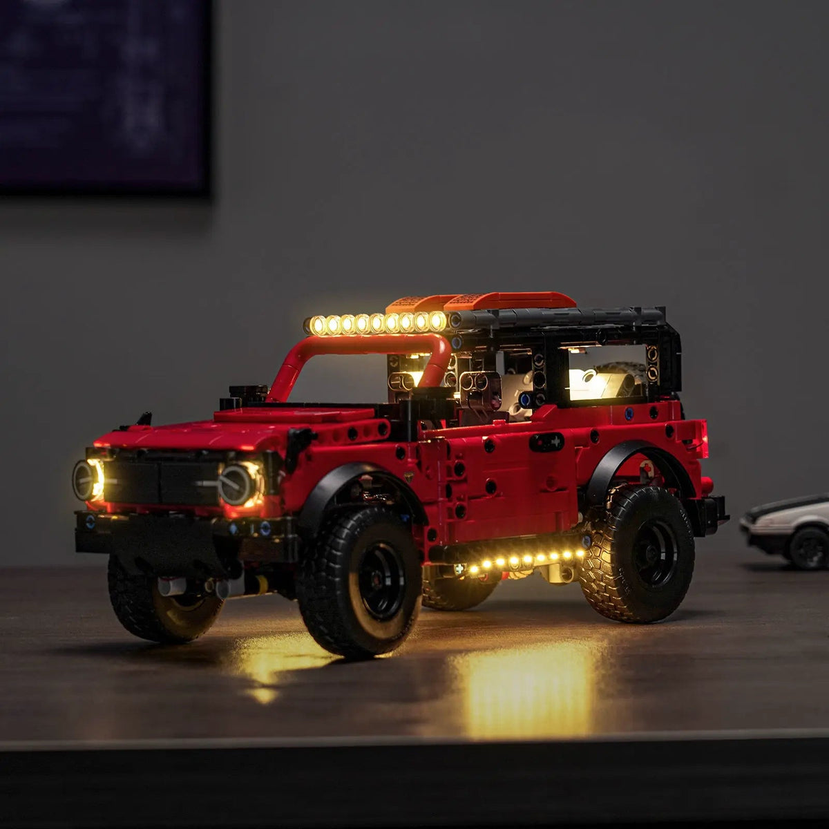 LEGO® Technic Ford Bronco SUV #42213 warm LED glow detail, with the premium LED light kit
