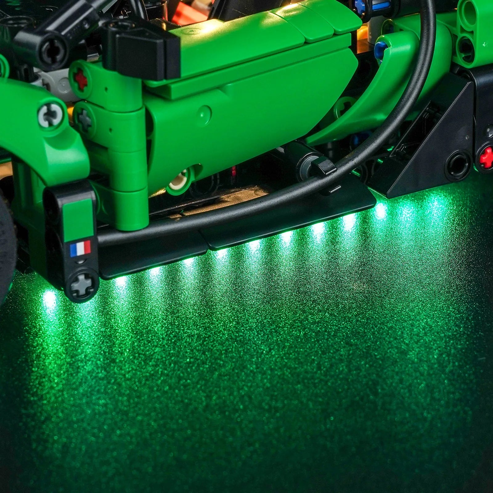 LEGO Technic Green Bugatti Chiron Pur Sport Hypercar #42241 illuminated at night