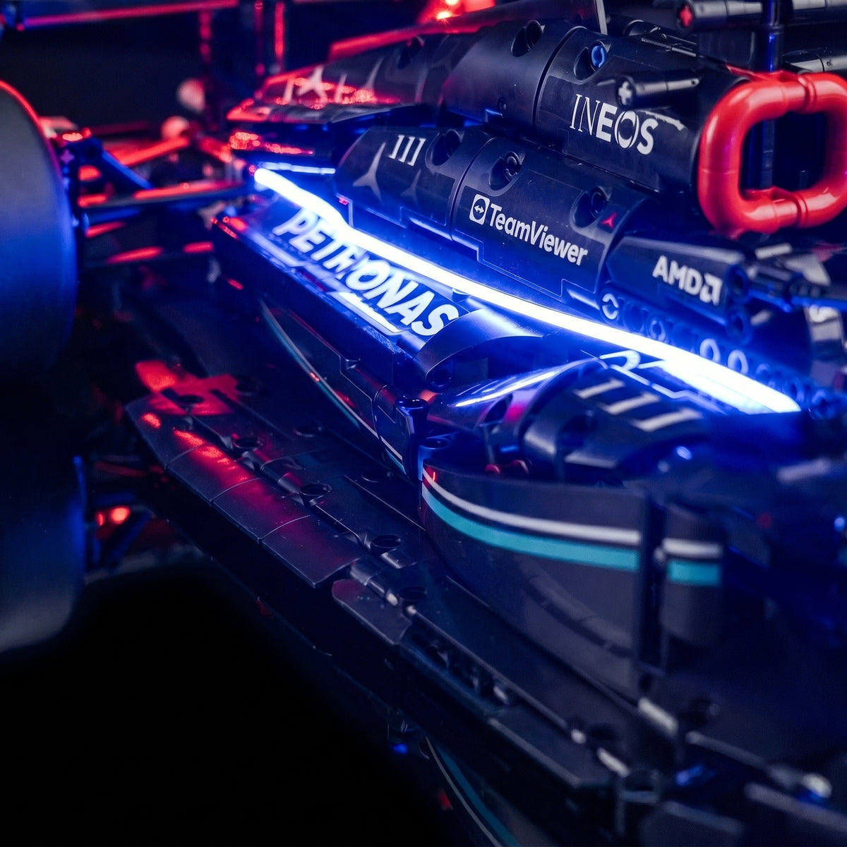 LEGO® Technic Mercedes-AMG F1 W14 E Performance #42171 display lighting in a dark room, with the DIY LED light kit