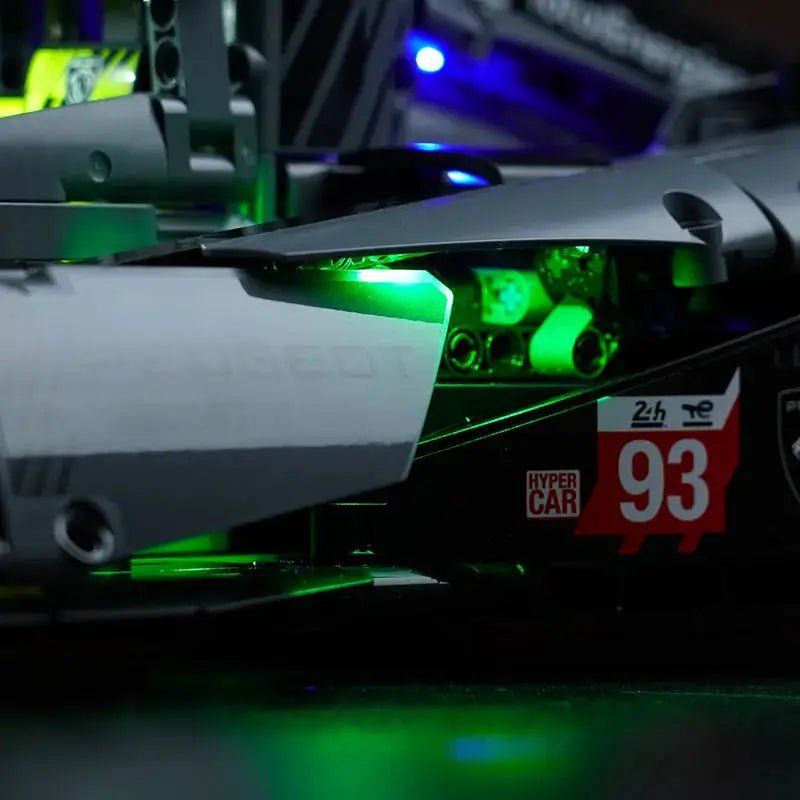 LEGO® Technic Peugeot 24H Le Mans Hybrid Hypercar #42156 illuminated at night, with the LED lights